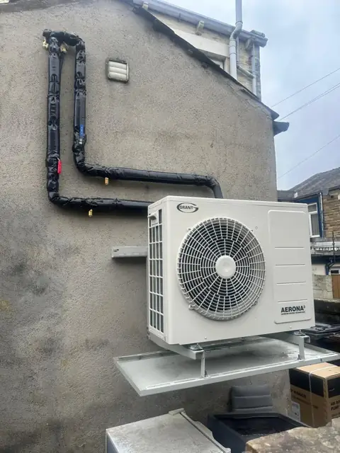Grant Aerona3 air source heat pump mounted on a wall bracket